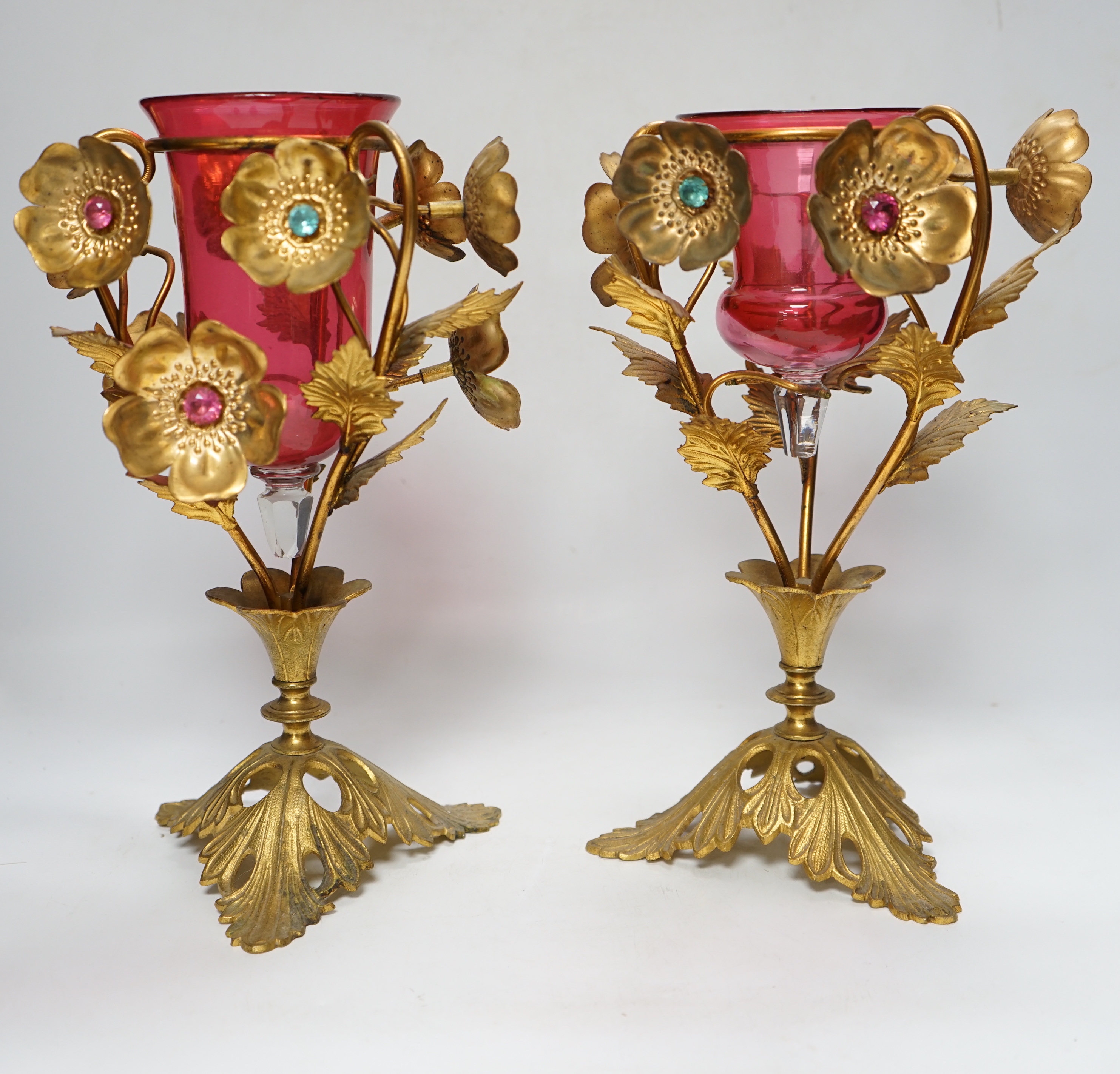 A near pair of early 20th century cranberry glass and gilt metal ornate vases, 31cm